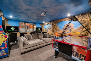 Themed games room has 110 inch screen, theater seats, air hockey and much more!