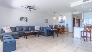 Large leather sectional sofa, leather ottomans for extra seating, dining table and kitchen.