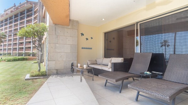 The patio is large with a sofa, chaise lounge chairs and dining table for six.