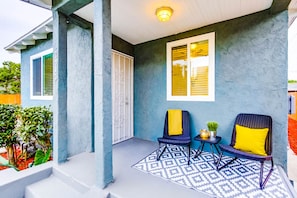 Tranquil front patio space with seating for two.