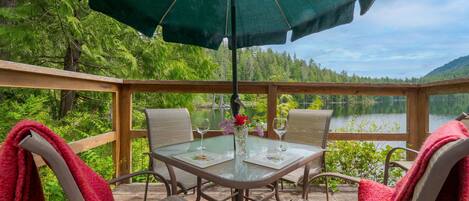 Outdoor dining space on your own private deck overlooking the lake.