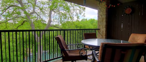 The covered balcony offers views of the river, great for sipping coffee in the morning or watching tubers float by during an outdoor dinner.