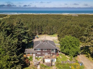 Experience seaside luxury at Bloomer Mansion, just a ten-minute stroll through a private wooded trail to the ocean's edge.