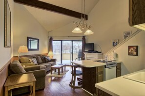 Living/Dining room - The queen-sized sleeper sofa is in the living room along with a separate chair. Also a flat screen tv with cable & DVD player. Off the living room is the walk-out screened in patio with seating for two.