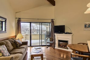 Living room - The queen-sized sleeper sofa is in the living room along with a separate chair. Also a flat screen tv with cable & DVD player. Off the living room is the walk-out screened in patio with seating for two.