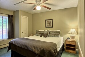 King-size bed - The bedroom in this unit has a comfortable king sized bed, two bedside tables, a dresser, closet and TV with cable.