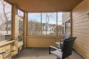 Patio - This unit also includes a spacious patio off of the living room where you can relax with a nice cup of coffee in the morning or enjoy an amazing Northern Michigan sunrise. It includes a love seat, a couple of chairs and a table.