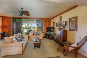 Living Area with Private Lanai, Sofas, Accent Chair, Ceiling Fan, and Smart TV