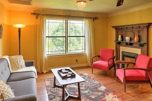 The living room features a large window, allowing in ample natural light.