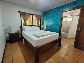 Main bedroom: queen bed, A/C unit and private bathroom