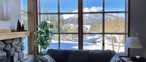 Picture windows define the living area, opening up to gorgeous mtn & golf views