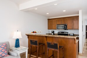 fully stocked kitchen open to the living area