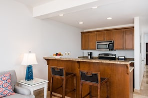 fully stocked kitchen open to the living area