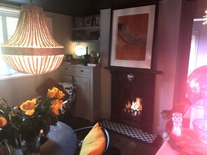 Cosy dining room with booth seating, a flame gas fire. The room overlooks garden