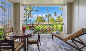 Ocean and beach view lanai! - Watch the whales breach from your lanai! There is a dining table with 4 chairs, a chaise lounge, and a side table