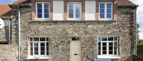 Front of Glatigny Farmhouse, south face walled garden with large bbq and pit.