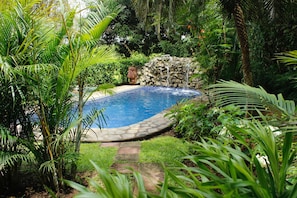 The condos private stone trail onto the tropical garden and deep water pool.