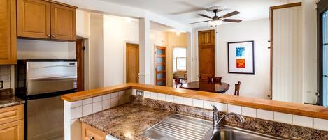 VIEW OF DINING ROOM FROM THE MODERN OPEN KITCHEN