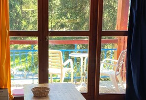 View of the balcony which has an outside table and chairs.