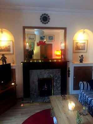Sitting room with fireplace that is gas-fired and feels like a real fire.