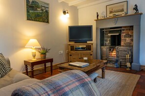 Cosy sitting room with open log fire.