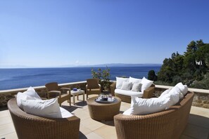 Separate outdoor lounge area with glorious evening sea view