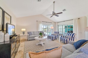 SW28503 - The inviting family room is equipped with a flat screen TV and offers beautiful lake and pool views