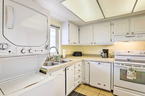 The washer and dryer are located in the kitchen.