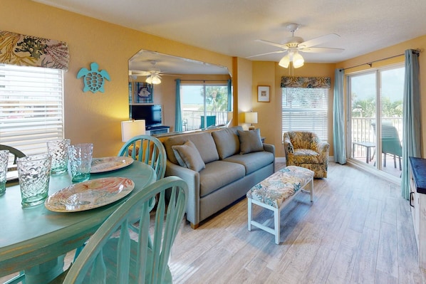 Family Room with Dining Area and Large Screen TV with Private Balcony Access.