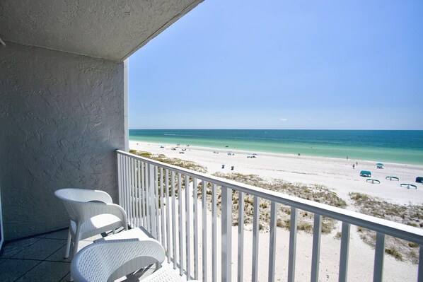 Spacious and private stateroom with beachfront balcony and unobstructed sunset views over the Gulf of Mexico.