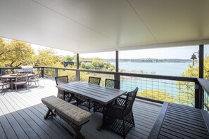 Shaded outdoor dining table. Gas grill with propane provided