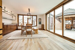 Large dining table with built in buffet, sliding doors open to spacious gazebo covered deck.