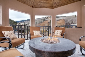 Mountain views surround the fire pit out on the deck.