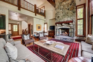 Great Room - Entry Level Great Room With Vaulted Ceiling, Two Story Stone Gas Fireplace, And Open Floor Plan