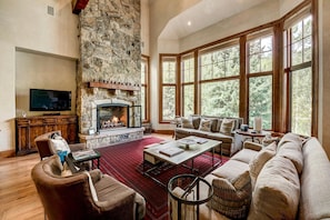 Great Room - Entry Level Great Room With Vaulted Ceiling, Two Story Stone Gas Fireplace, And Open Floor Plan