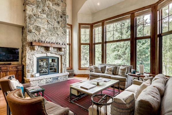 Great Room - Entry Level Great Room With Vaulted Ceiling, Two Story Stone Gas Fireplace, And Open Floor Plan