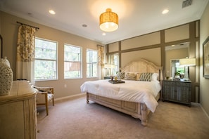 Simply stuning master suite with king sized bed and gorgeous view of lanai and preserve beyond.