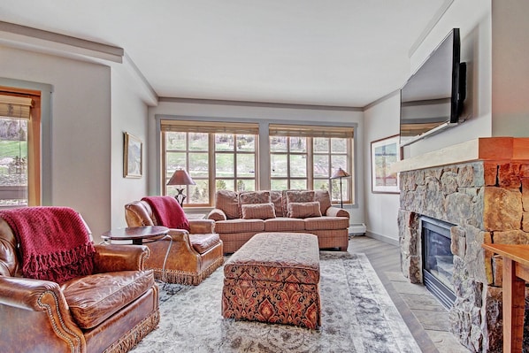 Living room features large windows letting in ample light.