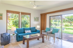 Kahala 312 Living Area with portable A/C - Beautiful views from this ground floor end unit living room that opens to rolling green lawns and the greenbelt walkway to the beach.