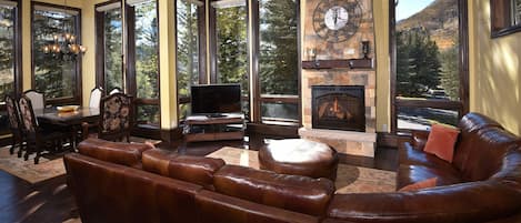 Potato Patch Club - a SkyRun Vail Property - Main level Living room / Family room with TV and fireplace with floor to ceiling windows so you can enjoy the most incredible year round views of Vail and the Rocky Mountains