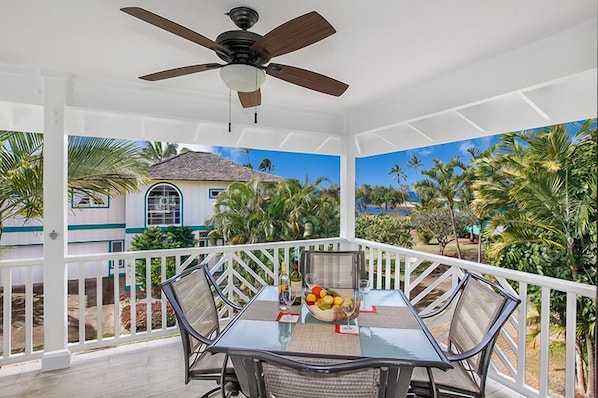 Kahele Kai large covered lanai - This charming home has whitewater and sunset views from the spacious lanai plus a BBQ grill, lovely furniture and furnishings, wall mounted A/C in living area & bedrooms, plus a portable in lower level family room & bedroom.