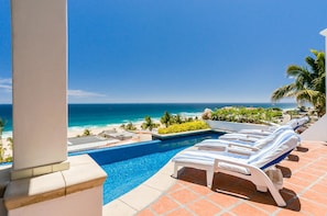 Ocean view patio with lounge and pool