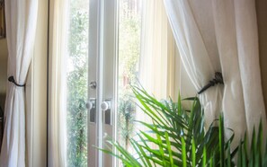 French doors open up to two small balconies off the bedroom.