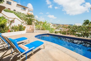 Patio with lounge chairs and pool