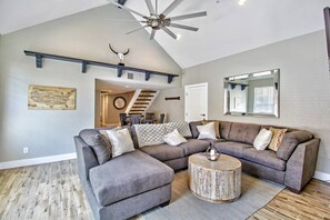 The living room area as you walk in the front door. Sectional couch with Queen size hideaway bed