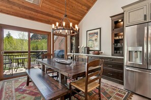 Dining room with seating for 6-8 features an elegant built in back bar with wine fridge.