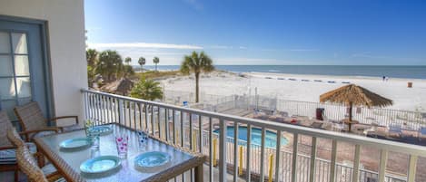 Enjoy a meal on your private balcony overlooking the pool and Madeira Beach