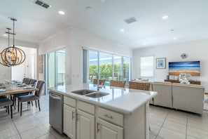 Bright and open Kitchen, Living and dining floor plan with access to the private pool and patio area