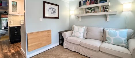 Living room has a drop down table for dining or work