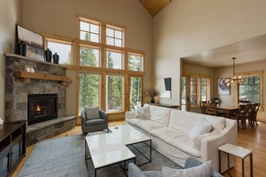 Living Room - Vaulted Ceiling, Fireplace, and Large Windows for Natural Lighting